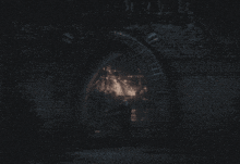 a person sits on a bench in the dark