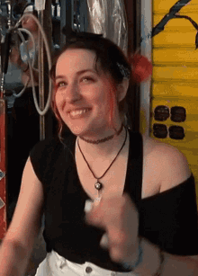 a woman with red hair is smiling and wearing a black shirt