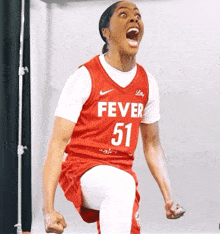 a female basketball player wearing a fever 51 jersey