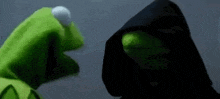 kermit the frog and darth vader from the muppets are standing next to each other in the dark .