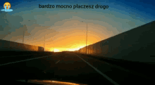 a picture of a highway with the words bardzo mocno placesz drogo on the bottom