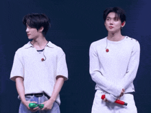 two men are standing next to each other and one has a green bottle in his hand