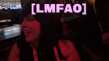 a woman is smiling in front of a sign that says ' lmfao '