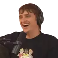 a man wearing headphones and a black shirt is laughing into a microphone