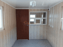 a hallway with a door and a window with the word " ubetoski " on the bottom