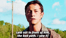 a man is standing in front of a tree and talking about a bad path .