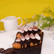 a croissant with chocolate sauce and whipped cream on top of it