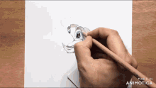 a person is drawing a cartoon character on a piece of paper with a pencil