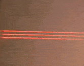 a person 's hand is pointing at a red laser