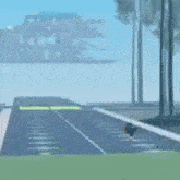 a car is driving down a road with palm trees on the side .