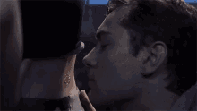 a man is kissing a woman 's neck in a close up of a movie .
