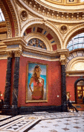 a painting of a woman in a pink bikini is hanging in a museum