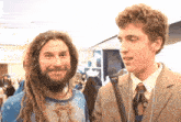 a man with dreadlocks is talking to another man