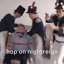 a group of men are standing around a man with a red tape around his mouth and the words hop on nightreign written below them