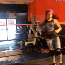 a woman in a tank top stands in a boxing ring with the hashtag #thenextbig thing at the bottom