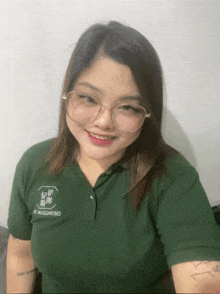 a woman wearing glasses and a green shirt that says chinodon on it