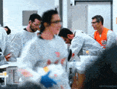 a man wearing an orange vest that says ' safety first '