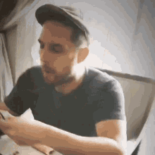 a man in a hat is sitting at a table