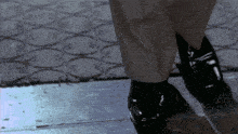 a close up of a person 's feet with a patterned rug in the background