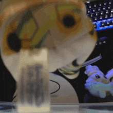 a blurred image of a stuffed animal with a bottle that says ec on it