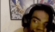 a close up of a person wearing headphones and making a funny face .