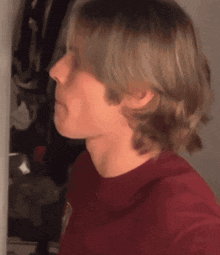 a close up of a person 's face with a red shirt
