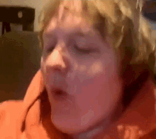 a close up of a person 's face with their eyes closed and their mouth open .