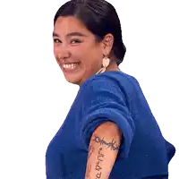 a woman in a blue sweater has a tattoo on her arm that says ' justice '