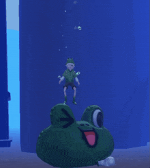 a boy in a frog hat is swimming next to a frog