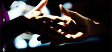 a close up of a person holding another person 's hand
