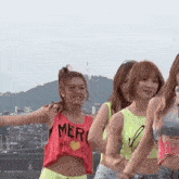 a group of girls are standing next to each other on a rooftop .