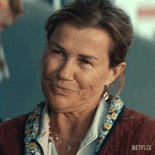 a close up of a woman 's face with a netflix logo in the background