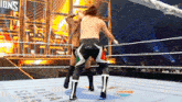 two men are wrestling in a ring with a sign that says riva seasons