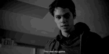 a black and white photo of a man standing in a hallway with the words `` this was my game '' .