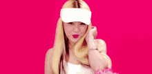 a blonde woman wearing a white visor and a white tank top