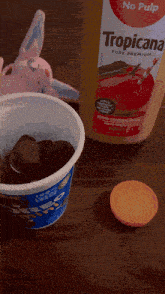 a bottle of pure premium apple juice sits on a table next to a container of yogurt