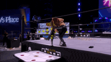 a wrestling match is taking place in front of a sign that says ' s place '