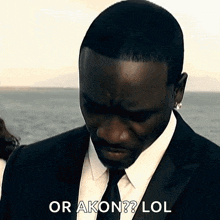 a man in a suit and tie says or akon lol .