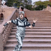 a person is standing on a set of stairs .