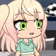 a girl with blonde hair and green eyes is wearing a shirt that says ' a ' on it