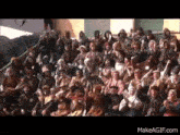 a large group of people dressed in medieval costumes are sitting in a crowd .
