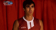 a man wearing a red and white shirt that says exatlon