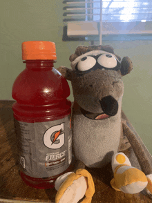 a stuffed animal next to a gatorade bottle