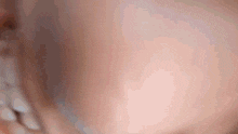 a close up of a baby 's face and neck