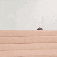 a woman is sitting on a couch and smiling