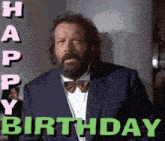 a man with a beard wearing a suit and bow tie says " happy birthday "
