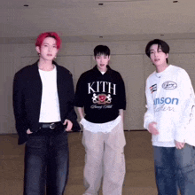 three young men standing next to each other with one wearing a shirt that says kith on it