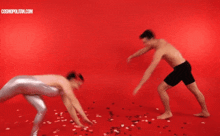 a man and a woman are doing a handstand on a red background with cosmopolitan.com in the corner