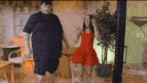a man and a woman are dancing in a living room .