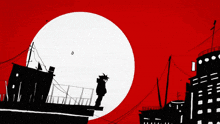 a silhouette of a man standing on top of a building